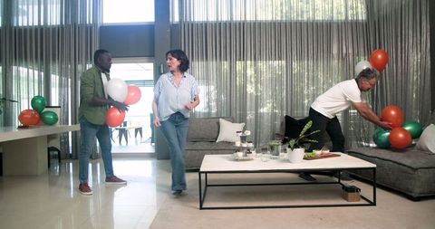 Diverse group decorates room in healthcare facility