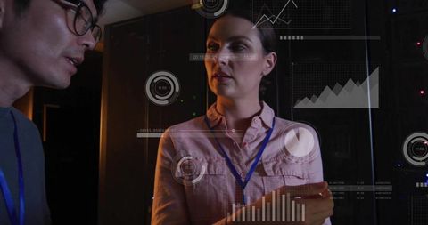 It technicians collaborating in data center monitoring server racks with hud analytics