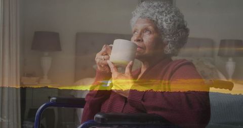 Senior woman relaxing with hot beverage in cozy bedroom setting