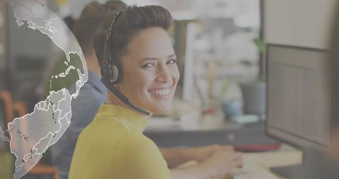 Smiling support specialist with digital globe overlay in workspace