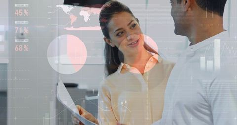 Businesswoman Presenting Reports to Colleague with Data Overlay and Analytics Charts