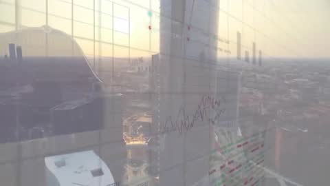 Cityscape with Overlay Charts Showing Financial Data Trends