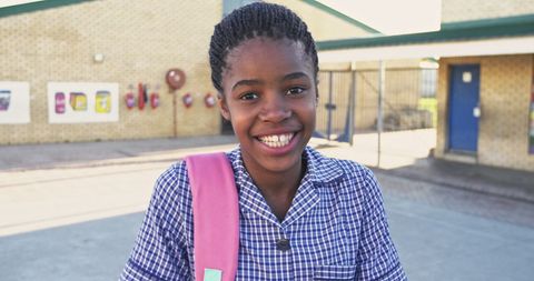 Joyful African Schoolgirl Smiling Outdoors in Uniform