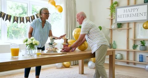 Senior Friends Celebrating Retirement with Snacks and Drinks