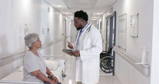 Doctor Consulting Patient on Hospital Gurney in Corridor - Download Free Stock Images Pikwizard.com