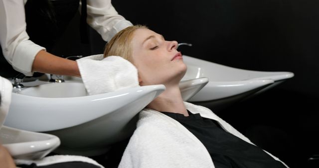 Woman Relaxing During Hair Wash at Salon - Download Free Stock Images Pikwizard.com