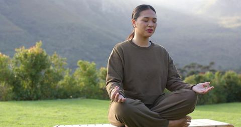 Woman Meditating Outdoors in Mountain Paradise