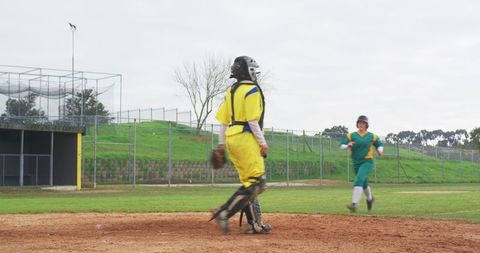 Sport Contest in Action: Two Youth Athletes Competing in Softball Game