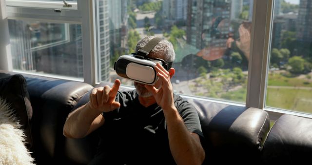 Mature Man Experiencing Virtual Reality in Modern City Apartment - Download Free Stock Images Pikwizard.com