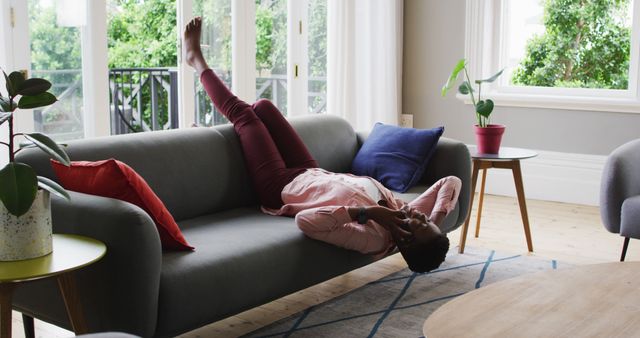 Young Woman Relaxing on Sofa at Home with Smartphone - Download Free Stock Images Pikwizard.com