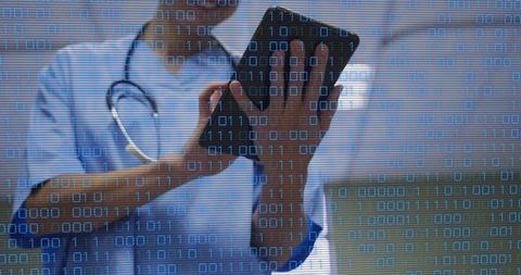 Healthcare Worker Holding Tablet Tapping Screen with Binary Code Overlay for Cybersecurity