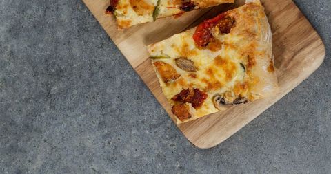 Tasty Homemade Pizza Slices Resting on Wood Runner - Download Free Stock Images Pikwizard.com