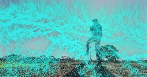 Silhouette with smartphone against digital data wave outdoors