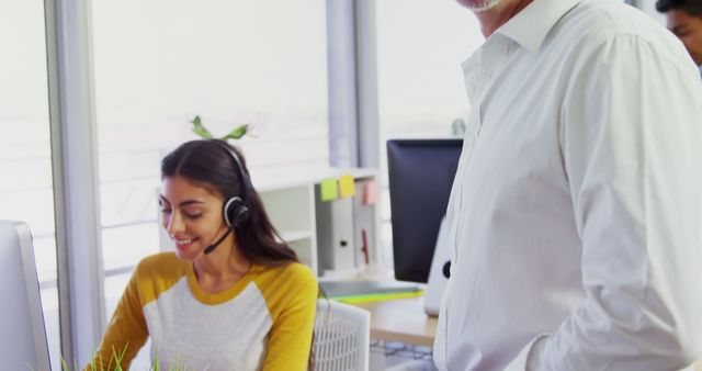 Smiling Customer Service Representative Wearing Headset Working in Modern Office - Download Free Stock Images Pikwizard.com