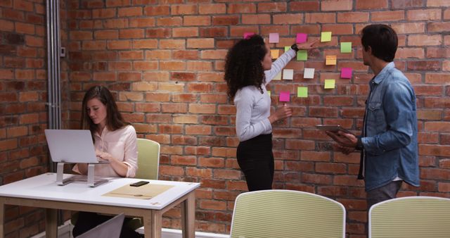 Young professionals brainstorming with sticky notes in modern office - Download Free Stock Images Pikwizard.com