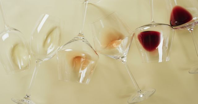 Perfect for themes involving wine appreciation, party planning, and elegant events. Can be used for advertisements for wine bars, lounges, and dining experiences. Suitable for articles discussing wine varieties and tasting techniques. Visually distinct with its artistic arrangement of wine glasses and remnants of beverages highlighting a sense of luxury and celebration.