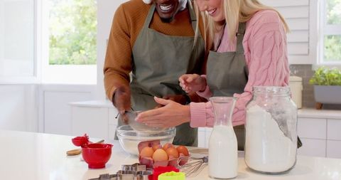 Diverse Couple Baking Together in Modern Home Kitchen