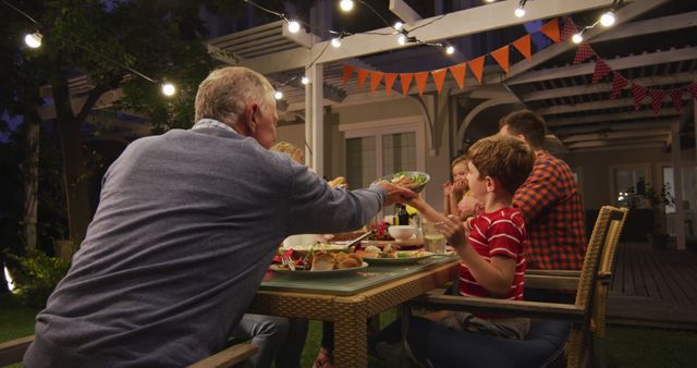 Family Enjoying Dinner Outdoors Under String Lights - Download Free Stock Images Pikwizard.com