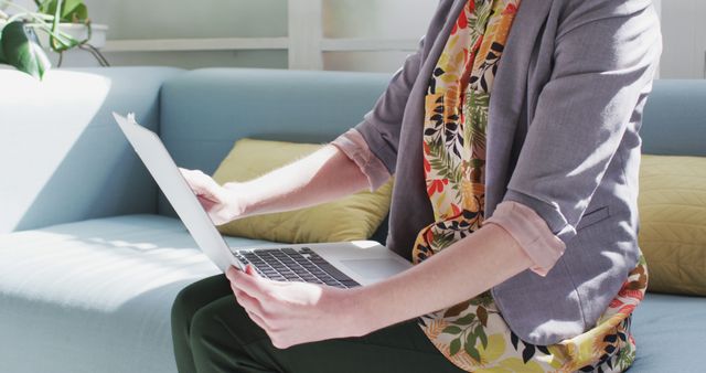 Woman Using Laptop on Couch in Bright Modern Living Room - Download Free Stock Images Pikwizard.com