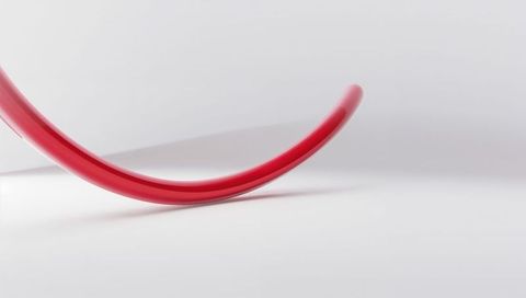 Glossy red arc on minimal white plane, abstract modern sculpture and geometric design