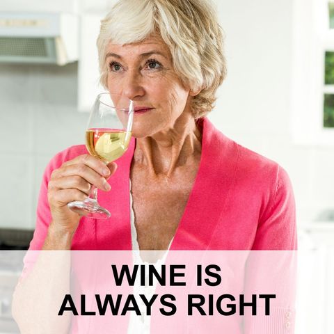 Senior woman enjoying glass of white wine at home