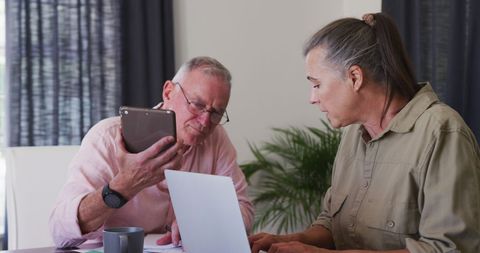 Elderly Couple Engaged with Modern Technology at Home - Download Free Stock Images Pikwizard.com