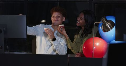 Cheerful late night business collaboration with diverse colleagues