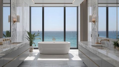 Oceanfront luxury bathroom with freestanding oval tub, gold faucet and marble vanities