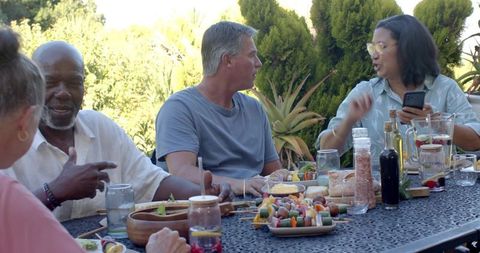 Diverse Friends Enjoying Outdoor Patio Gathering with Healthy Food