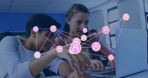 Teen students collaborating with digital network overlay in classroom