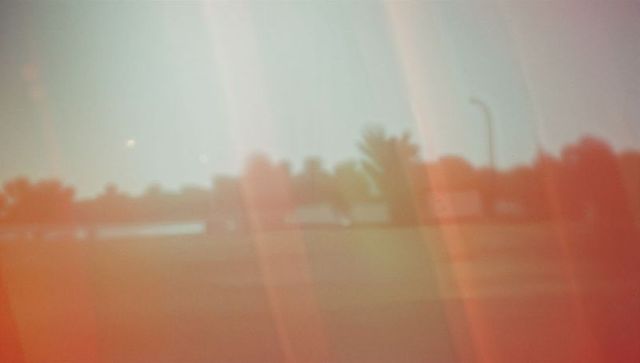 Vibrant Landscape Scene with Light Leaks and Streetlight