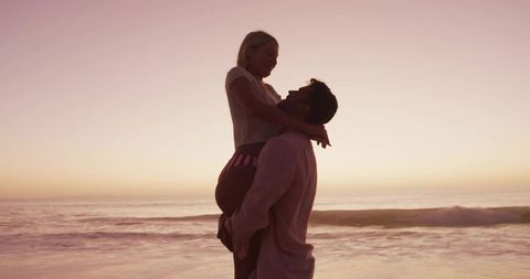 Romantic Sunset Embrace: Couple Enjoying Serene Beach Moments