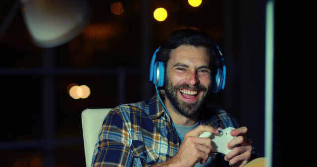 Happy Man Gaming at Night with Headphones - Download Free Stock Images Pikwizard.com