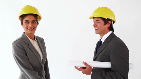 Smiling Architects Shaking Hands in Successful Partnership