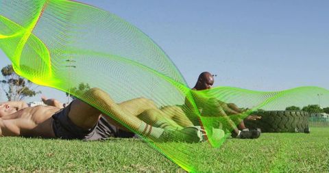 Shirtless men training core on sports field with heavy tire and neon mesh overlay