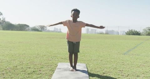 Young Boy Practicing Yoga Outdoors on Sunny Day