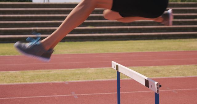 Athlete Jumping Over Hurdle on Track - Download Free Stock Images Pikwizard.com