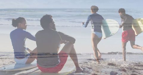 African American Couple Relaxing with Surfboards at Beach