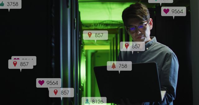 Young man monitoring social media activity on laptop in data center - Download Free Stock Images Pikwizard.com