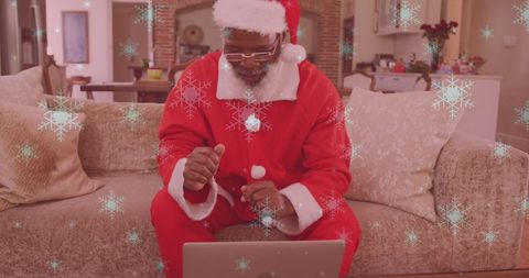 Man in Santa Costume Having Virtual Celebration with Falling Snow Effect