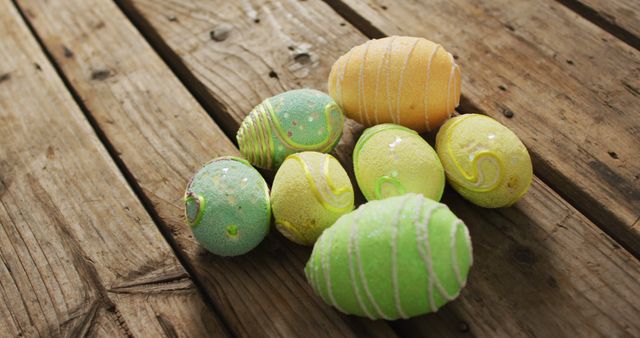 Image of decorated colorful easter eggs on a wooden surface. seasonal easter traditional sweet treats.