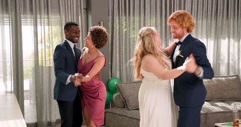 Joyful Wedding Celebration with Multiracial Couples Dancing