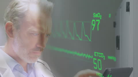 Caucasian Doctor Monitoring Heart Rate with Technology