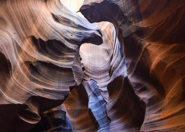 Antelope Canyon exhibits unique rock formations illuminated by natural light, highlighting intricate patterns and textures. Ideal for use in travel guides, nature publications, and educational content on geological formations.