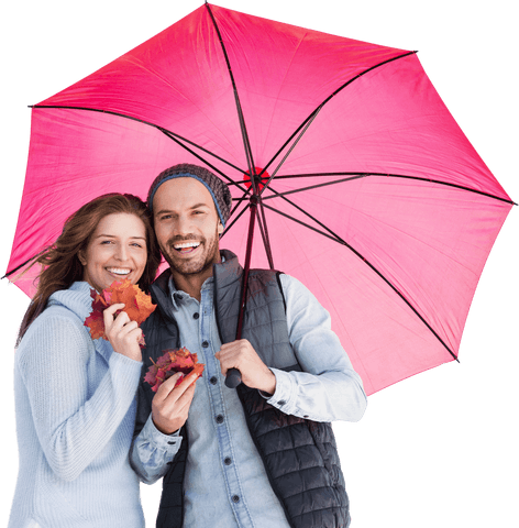 Happy couple under large pink umbrella holding autumn leaves transparent