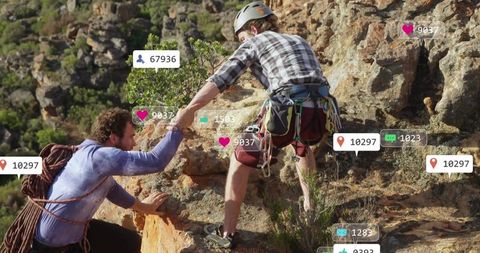 Adventurers Collaborating While Climbing Rocky Terrain