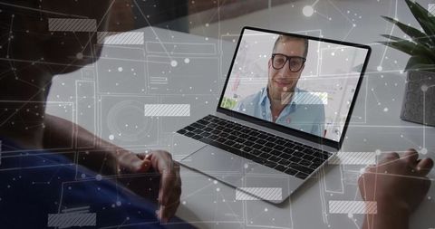 Doctor and Patient in Virtual Consultation via Laptop
