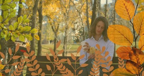 Young Man Relaxing with Coffee in Autumn Park