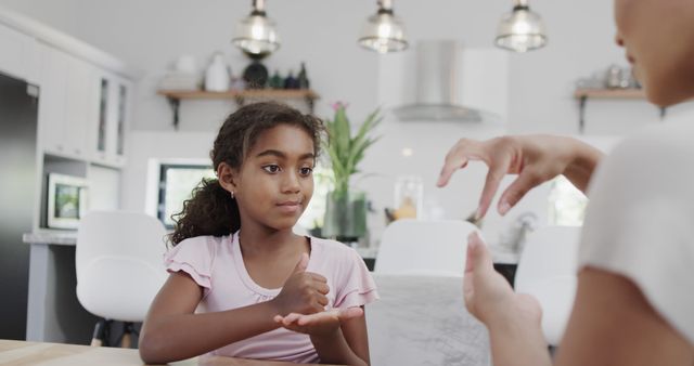 Young girl learning sign language at home with mother or tutor - Download Free Stock Images Pikwizard.com