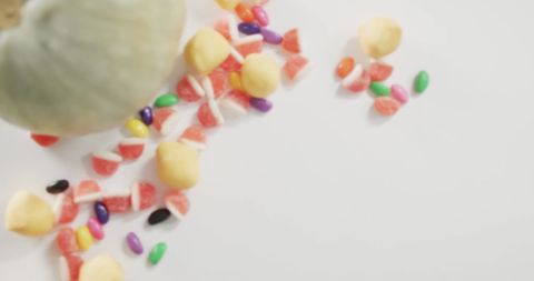 Colorful Halloween Candy Spilling on White Surface
